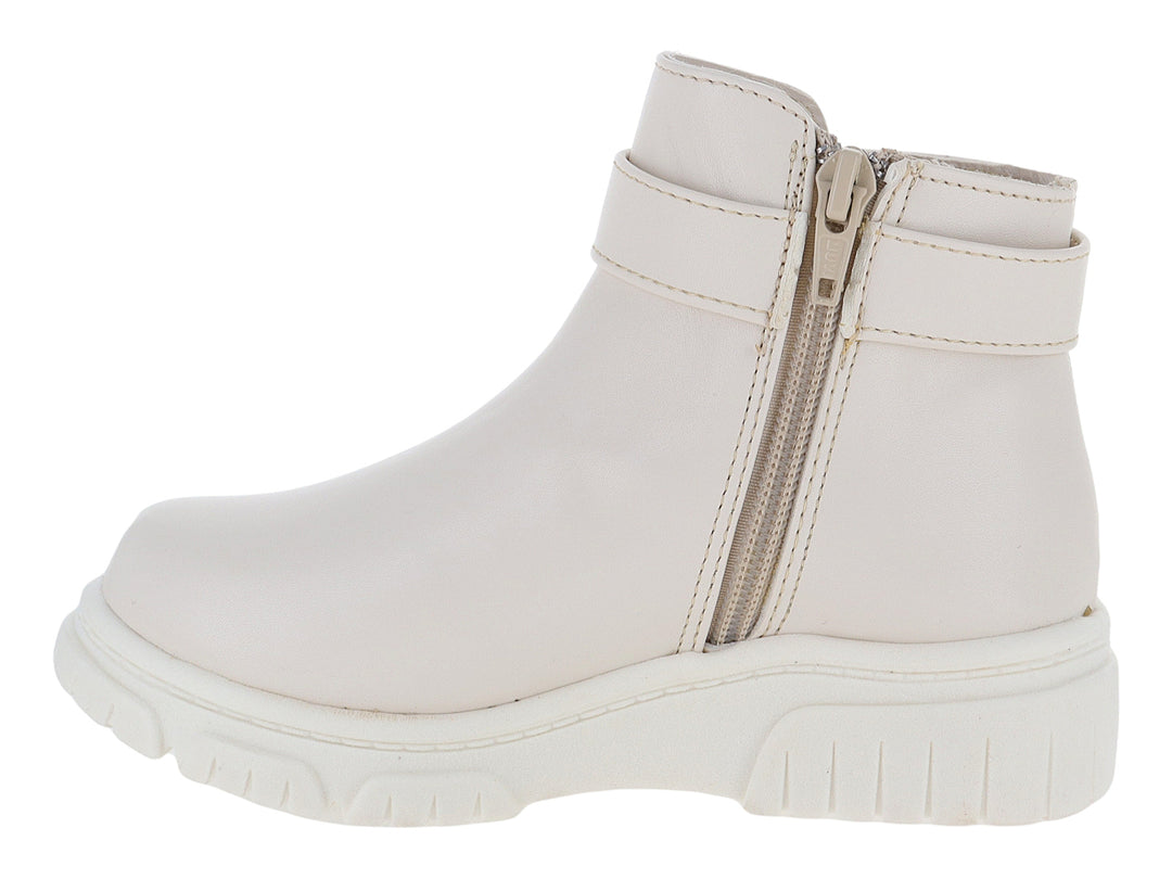 Botas color latte para niña con detalle de moño y corazón dorado en el tobillo y suela blanca gruesa.