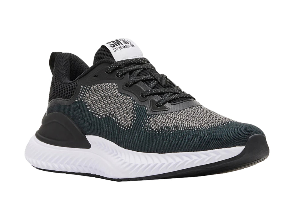 Tenis Steve Madden modelo Slater en color negro y gris con suela blanca gruesa.