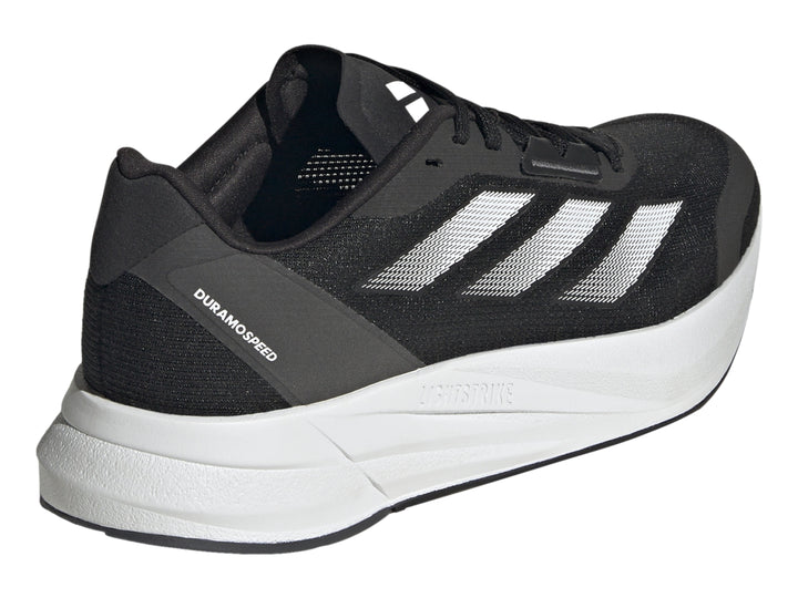 Tenis deportivos Adidas Duramo Speed en color negro con suela blanca y franjas plateadas laterales.