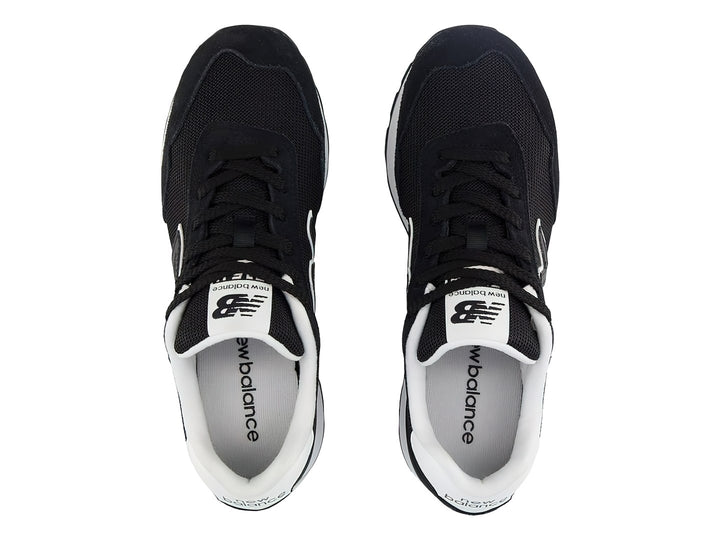Tenis New Balance color negro con suela de plataforma blanca y detalles en gris.