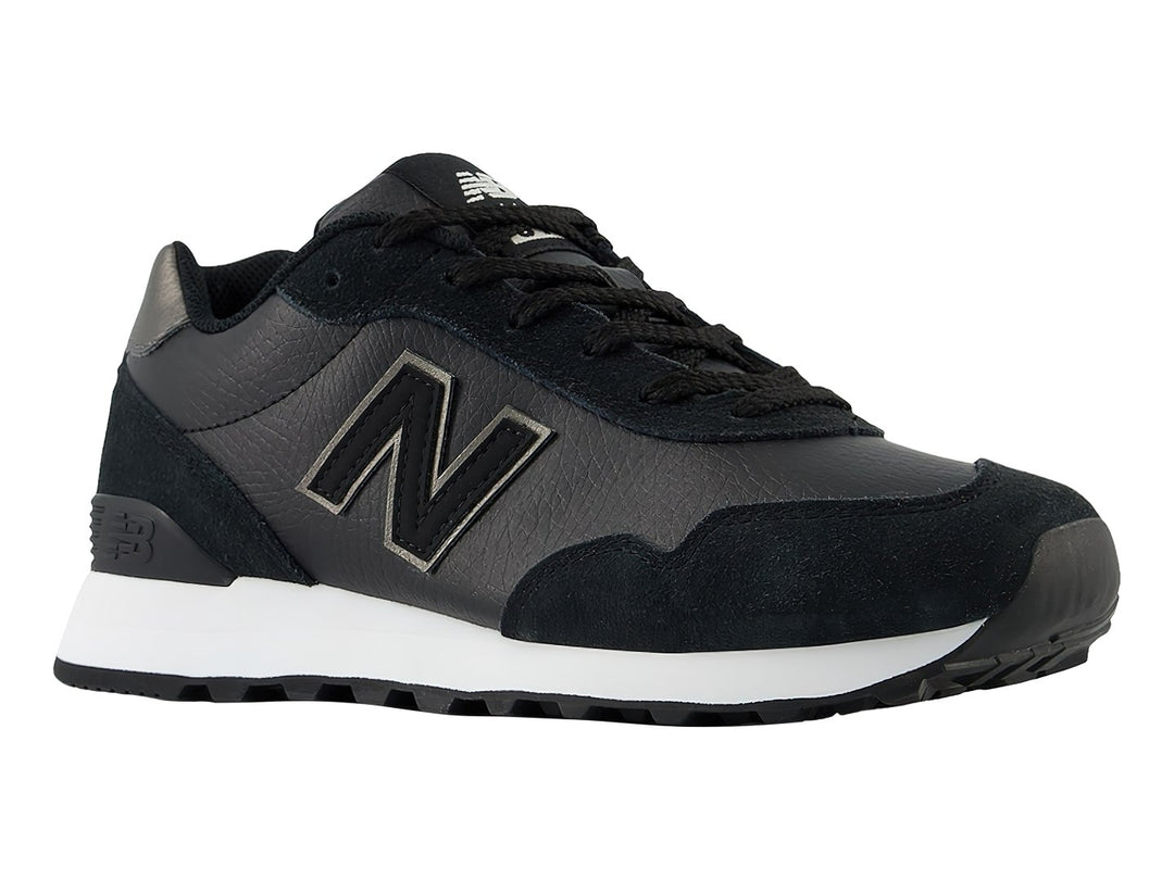 Tenis New Balance 515 color negro con suela blanca y detalles en gris en el talón.