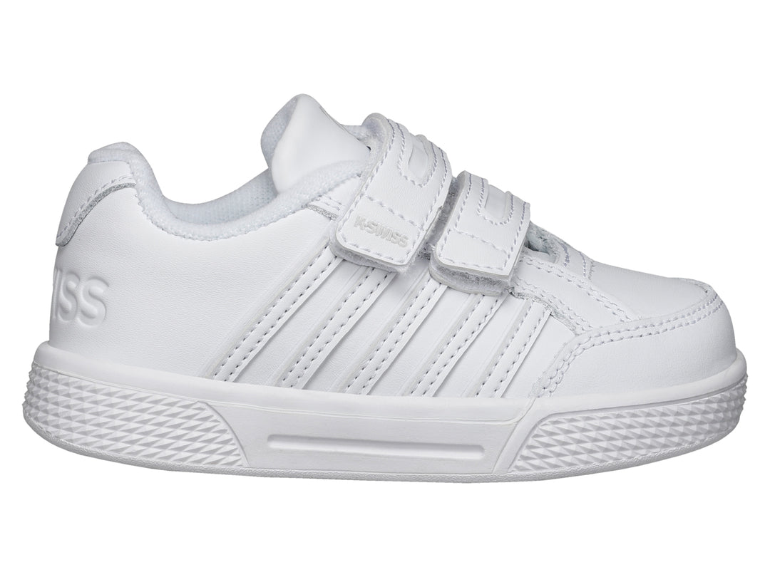 Tenis blancos K-SWISS para niños con cierre de velcro y suela blanca.