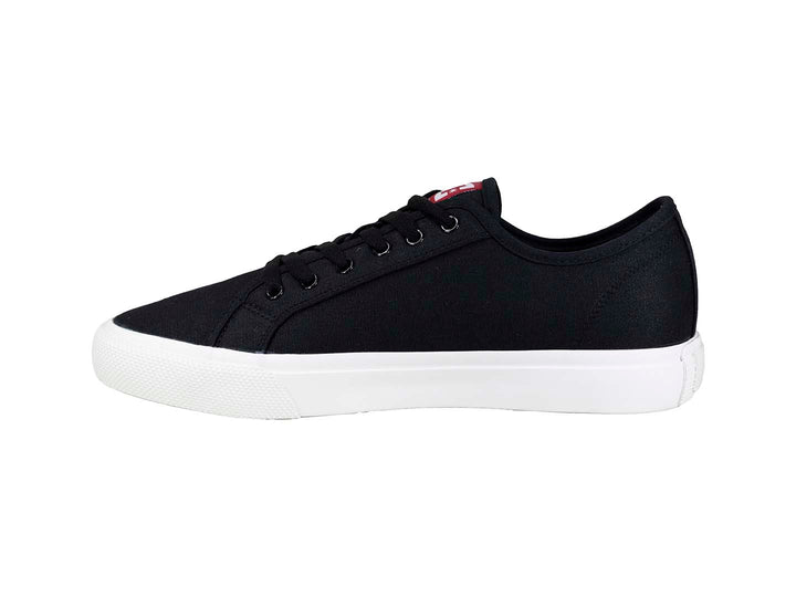 Tenis DC Shoes color negro con suela blanca y detalle en rojo, estilo casual.