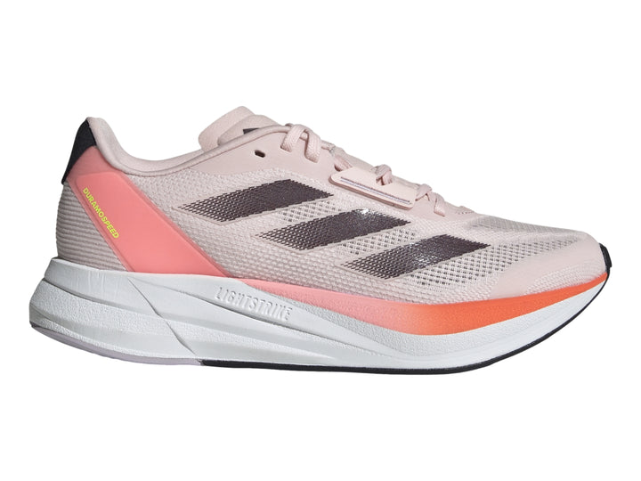 Tenis deportivos Adidas color rosa con franjas grises, detalles naranjas y suela blanca.