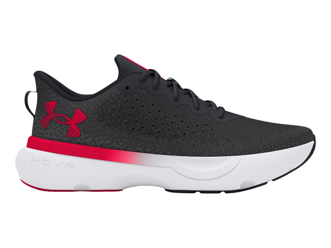 Tenis deportivos Under Armour color negro con suela blanca y detalles en rojo.