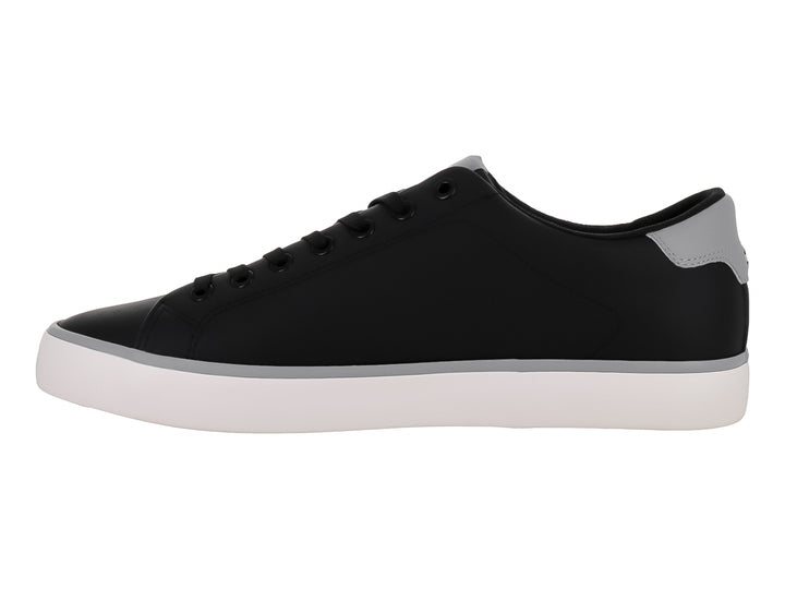 Tenis casuales Tommy Hilfiger en color negro con suela blanca y detalles en gris.