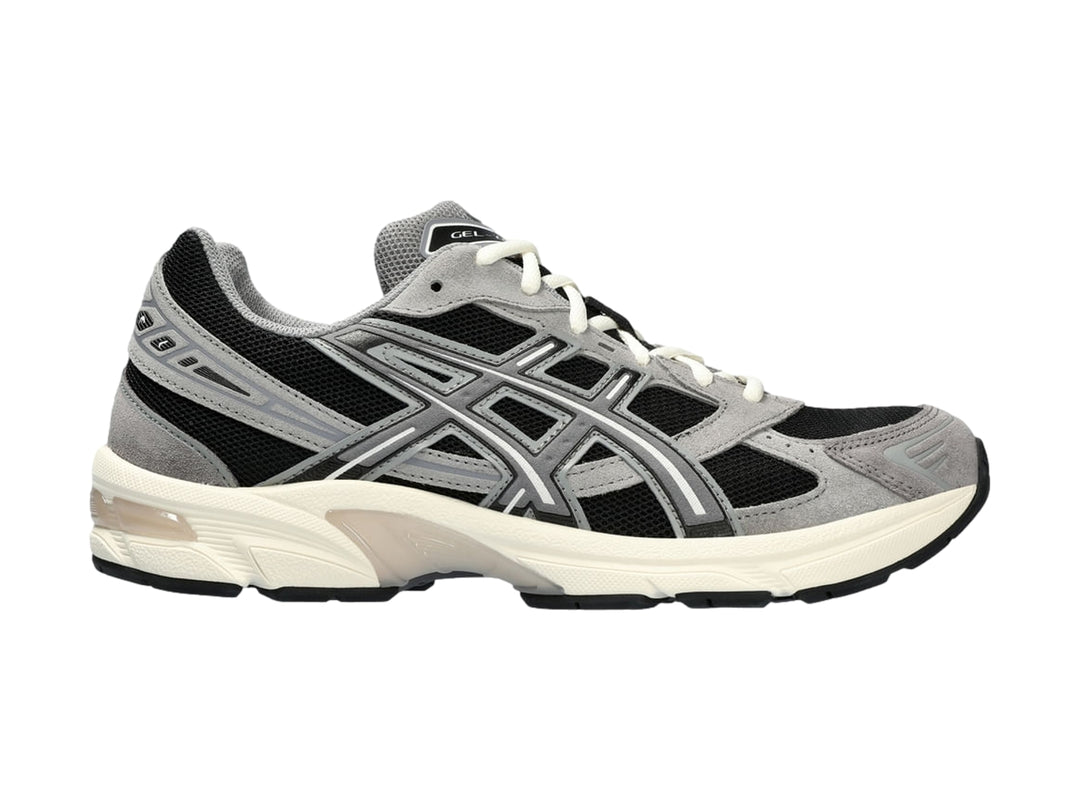 Tenis deportivos ASICS GEL-1130 en color gris y negro con suela blanca.