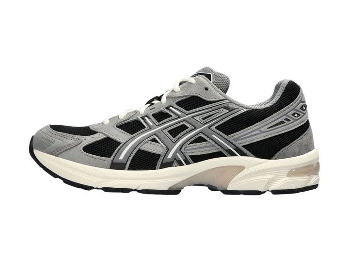 Tenis deportivos ASICS GEL-1130 en color gris y negro con suela blanca.