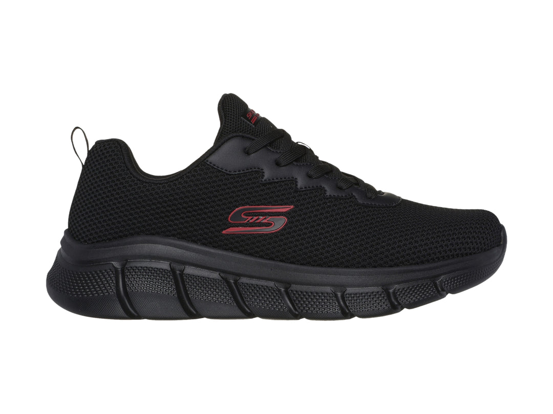 Tenis deportivos Skechers color negro con suela gruesa y detalles en rojo.