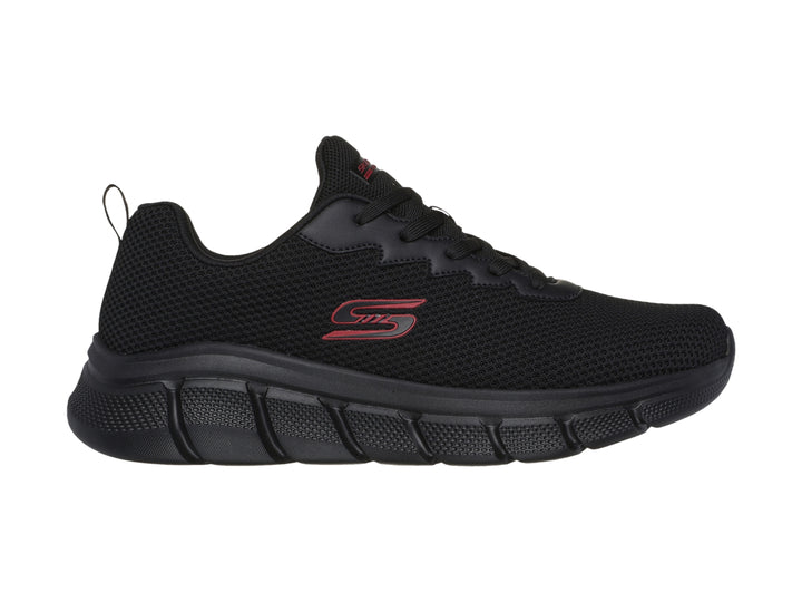 Tenis deportivos Skechers color negro con suela gruesa y detalles en rojo.