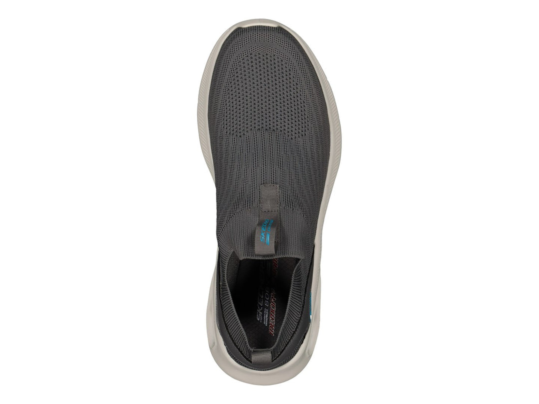 Tenis Skechers color gris con suela blanca y detalles en azul claro, estilo slip-on sin cordones.