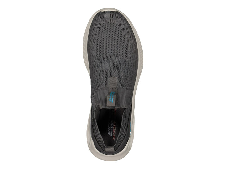 Tenis Skechers color gris con suela blanca y detalles en azul claro, estilo slip-on sin cordones.
