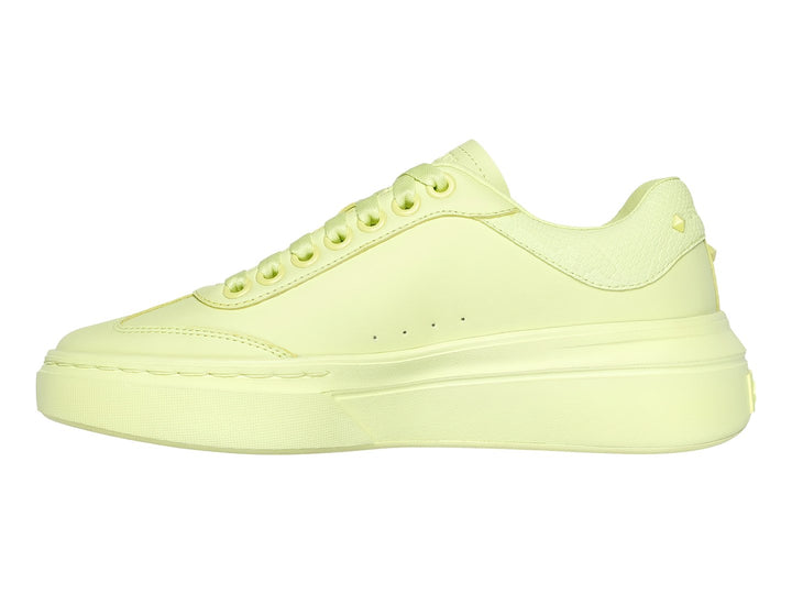 Tenis Skechers color lima monocromático con suela de plataforma y cordones.