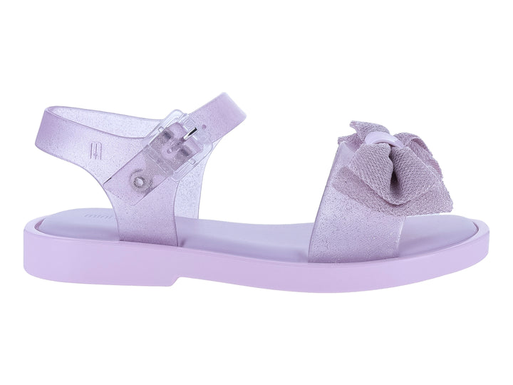 Sandalia infantil Mini Melissa color rosa lila con moño decorativo y acabado brillante.