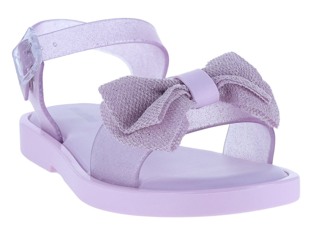 Sandalia infantil Mini Melissa color rosa lila con moño decorativo y acabado brillante.
