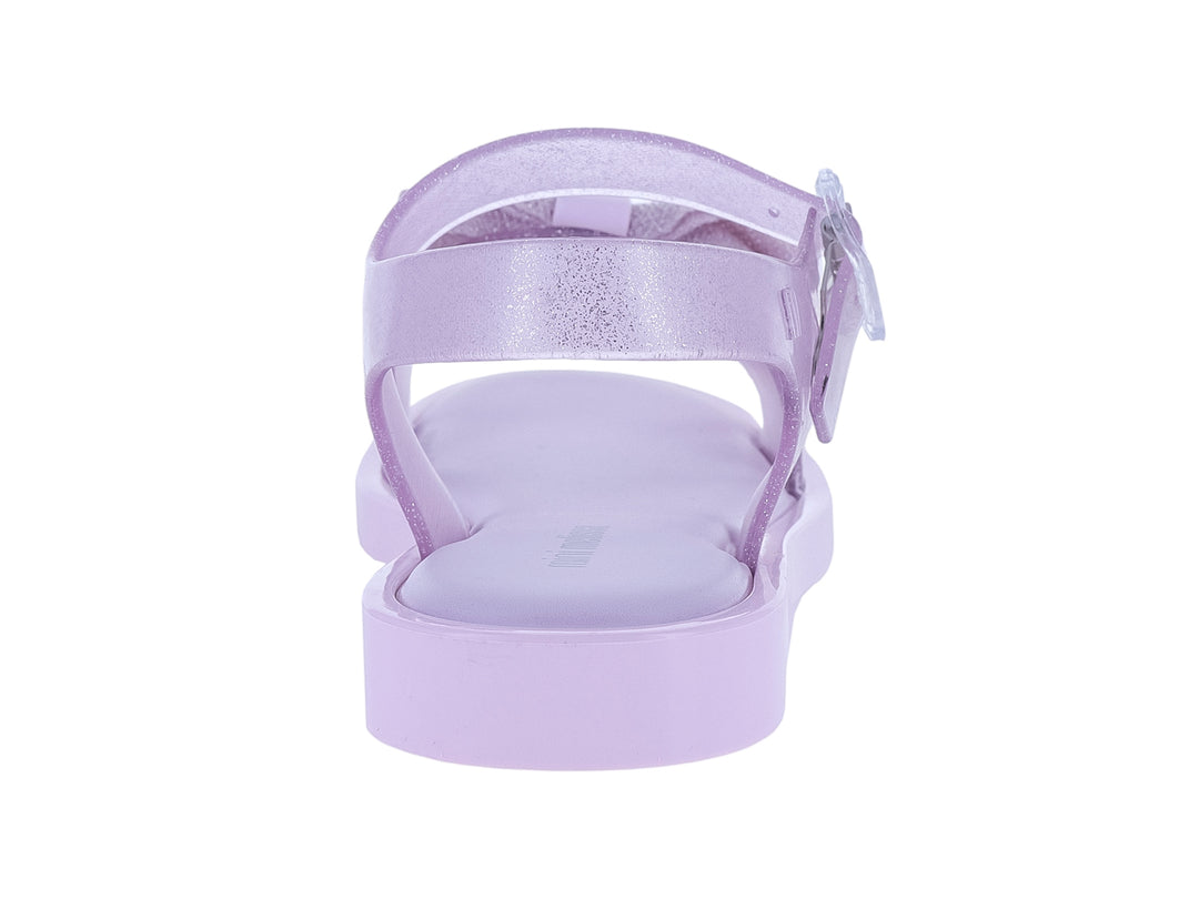 Sandalia infantil Mini Melissa color rosa lila con moño decorativo y acabado brillante.