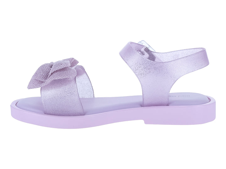 Sandalia infantil Mini Melissa color rosa lila con moño decorativo y acabado brillante.