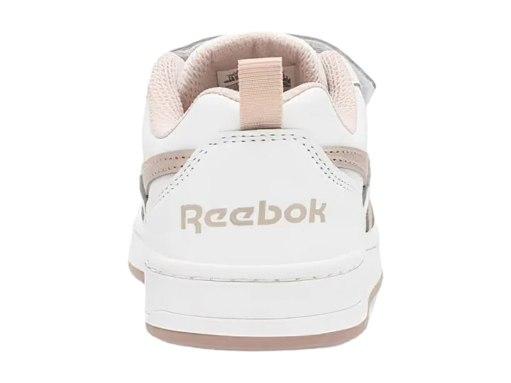 Tenis blancos Reebok con cierres de velcro y detalles en color dorado.