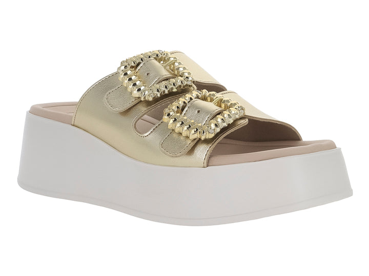 Sandalia Beira Rio color dorado con plataforma blanca y hebillas ornamentadas.