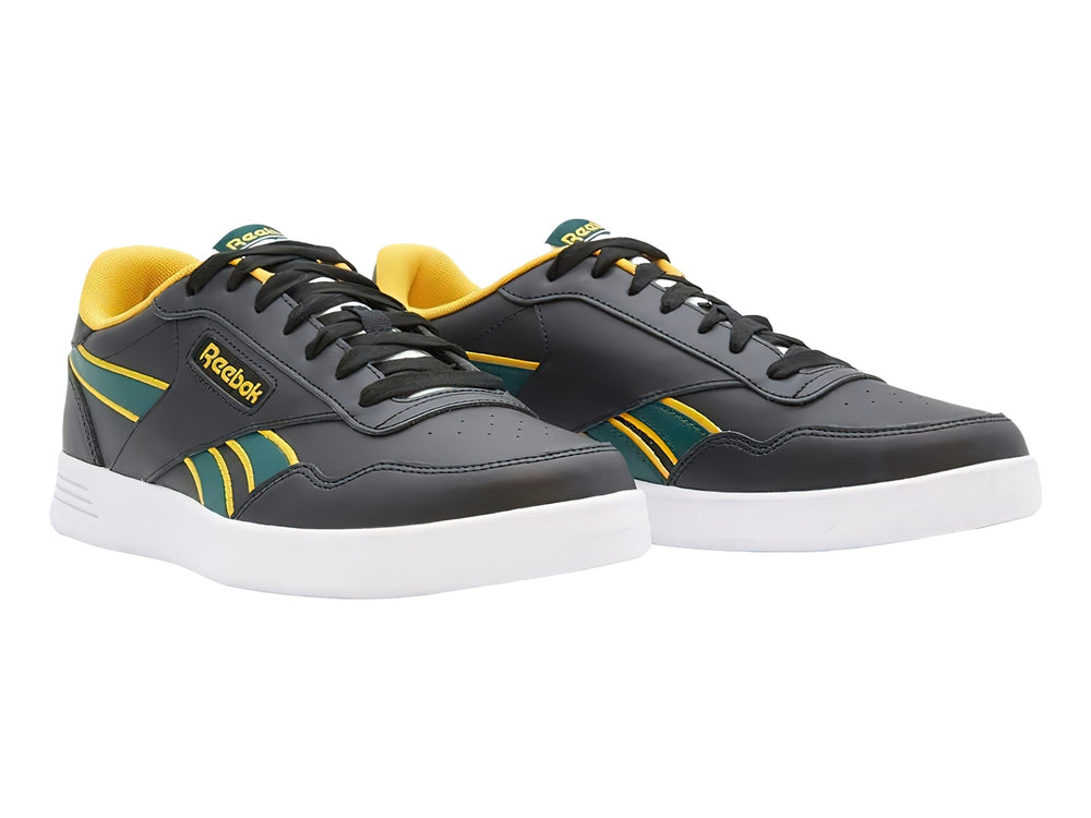Tenis deportivos Reebok color negro con detalles en amarillo y verde y suela blanca.