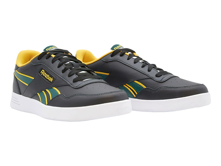 Tenis deportivos Reebok color negro con detalles en amarillo y verde y suela blanca.