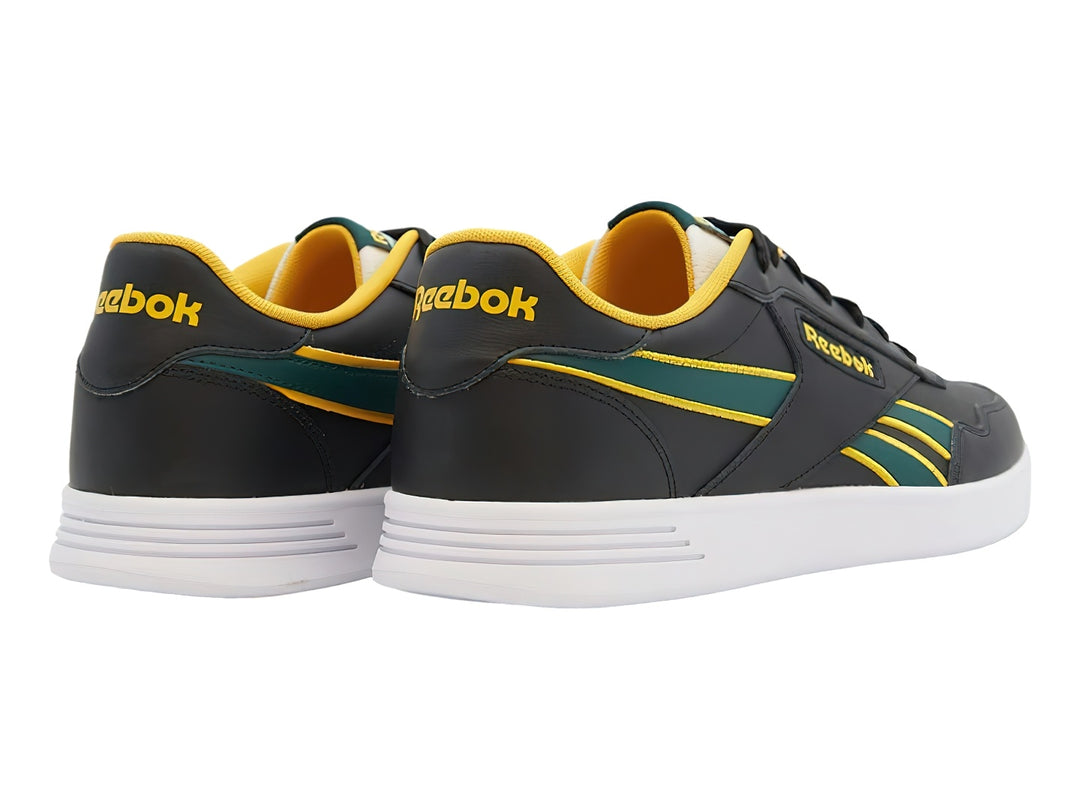 Tenis deportivos Reebok color negro con detalles en amarillo y verde y suela blanca.