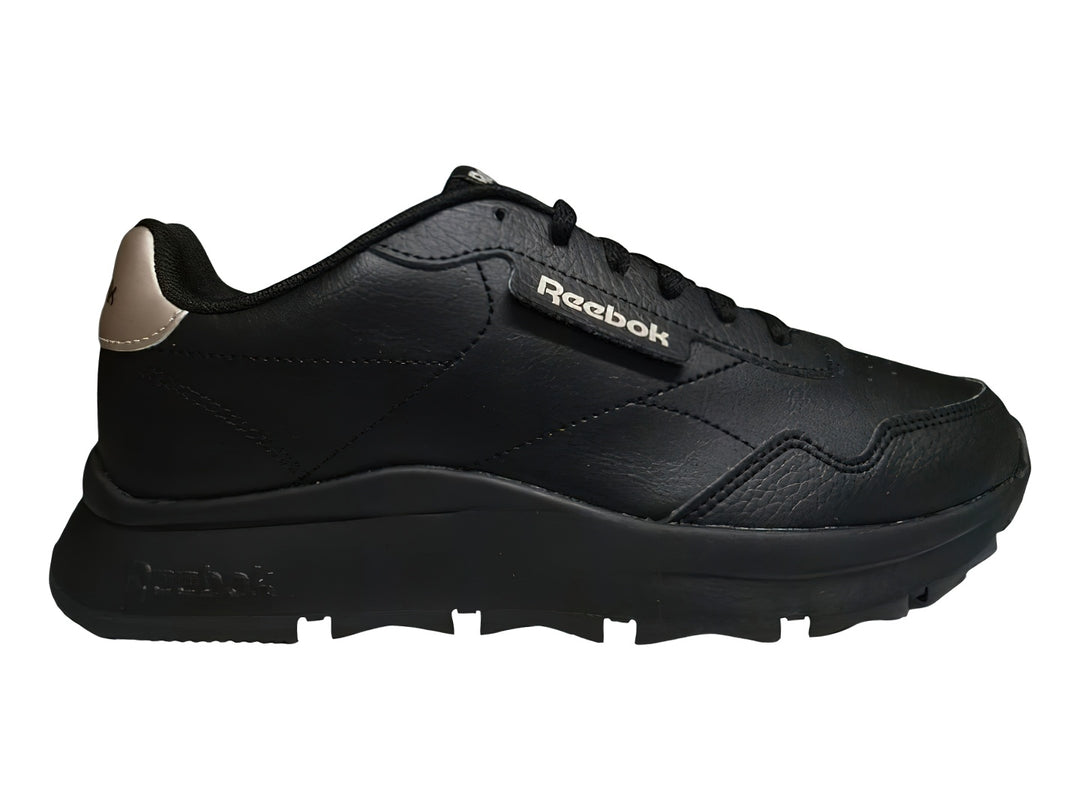 Tenis Reebok color negro con detalles en dorado y suela gruesa dentada.