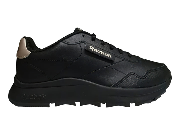 Tenis Reebok color negro con detalles en dorado y suela gruesa dentada.