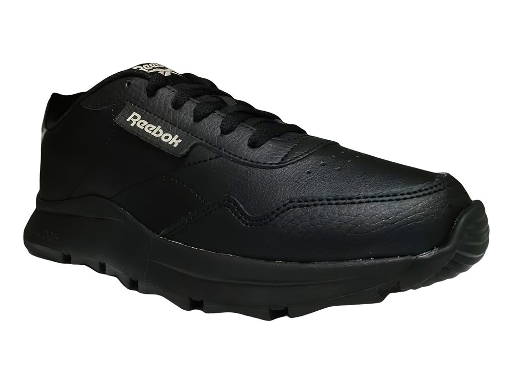 Tenis Reebok color negro con detalles en dorado y suela gruesa dentada.