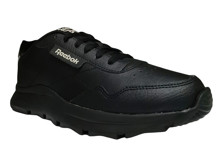Tenis Reebok color negro con detalles en dorado y suela gruesa dentada.