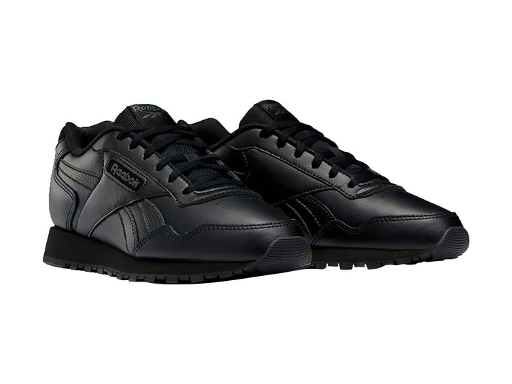 Tenis deportivos Reebok Glide 22 en color negro total con suela texturizada y agujetas negras.