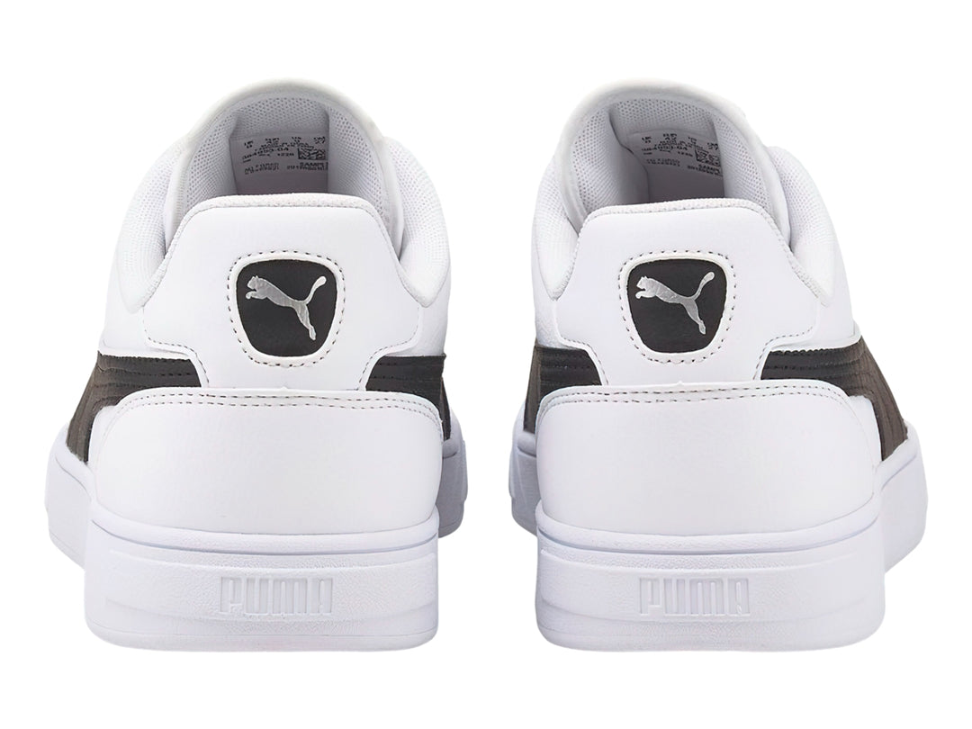 Tenis PUMA Caven Dime en color blanco con franja lateral negra y suela blanca.