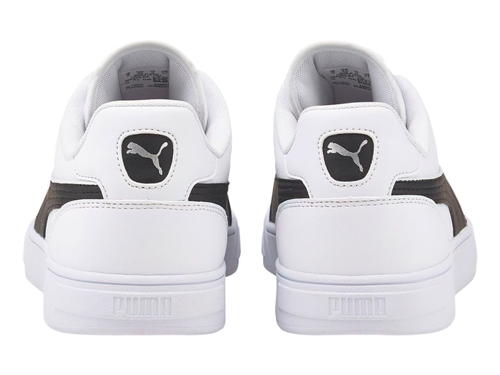 Tenis PUMA Caven Dime en color blanco con franja lateral negra y suela blanca.
