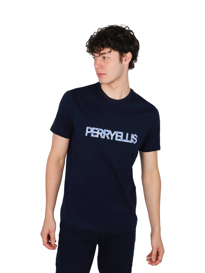 Hombre vistiendo camiseta de manga corta color azul marino con logotipo de Perry Ellis en el pecho.