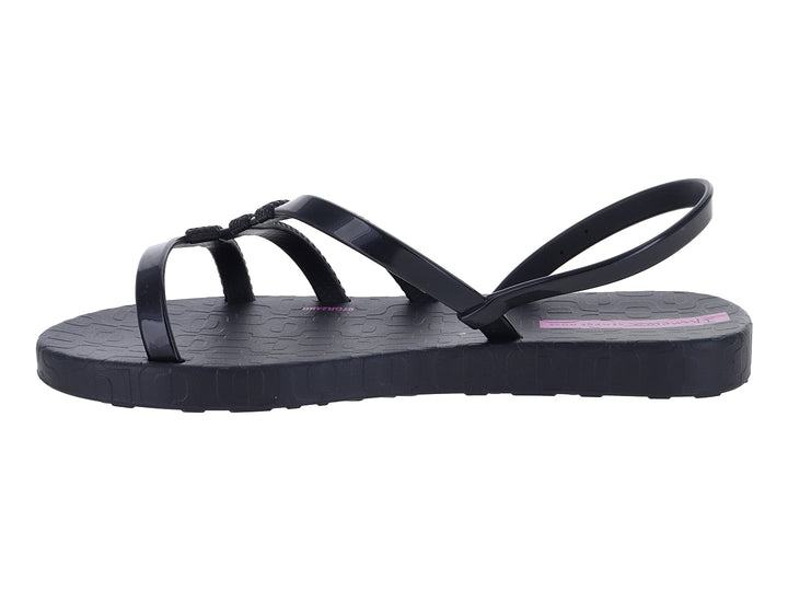 Sandalia infantil Ipanema de color negro con tiras texturizadas y logotipo en color lila.