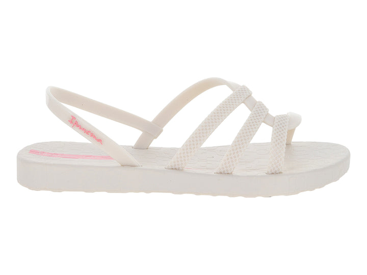 Sandalia infantil Ipanema de color hueso con tiras cruzadas y detalles en rosa.