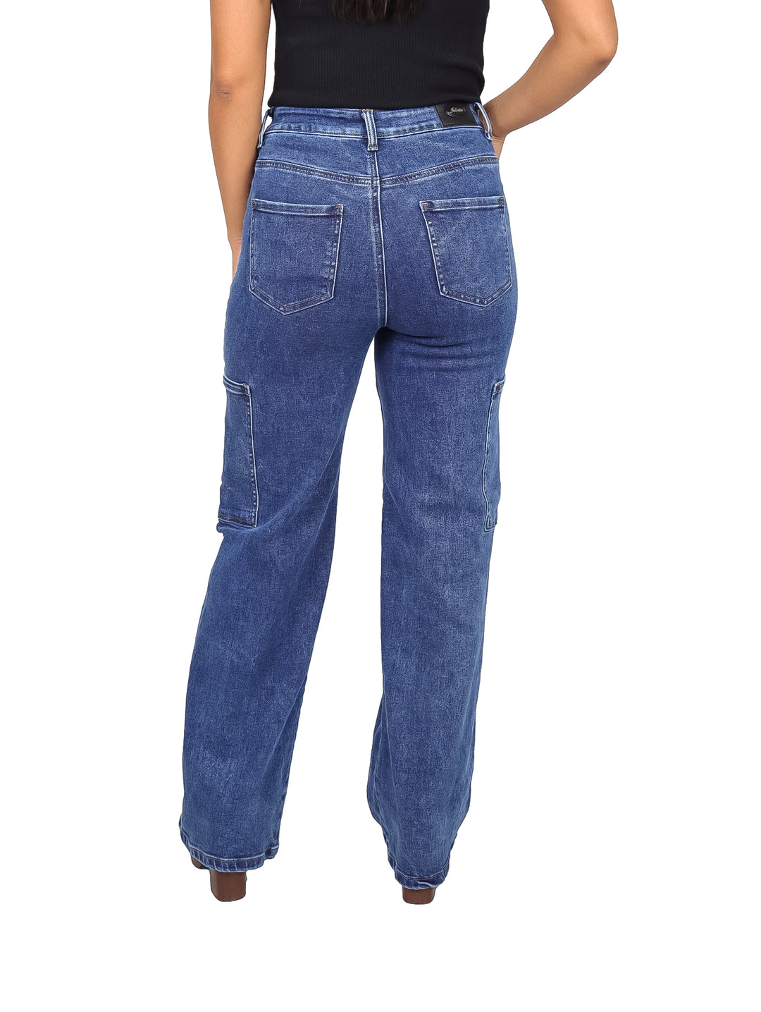 Mujer vistiendo pantalones jeans cargo de mezclilla color azul con bolsillos laterales.