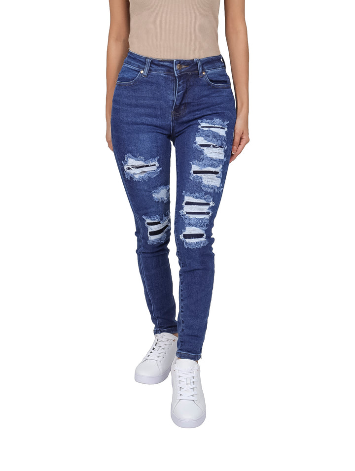 Jeans skinny color azul con efecto de destrucción en las piernas.