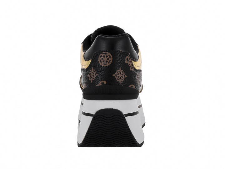 Tenis negros de plataforma Guess con detalles dorados y suela blanca gruesa.