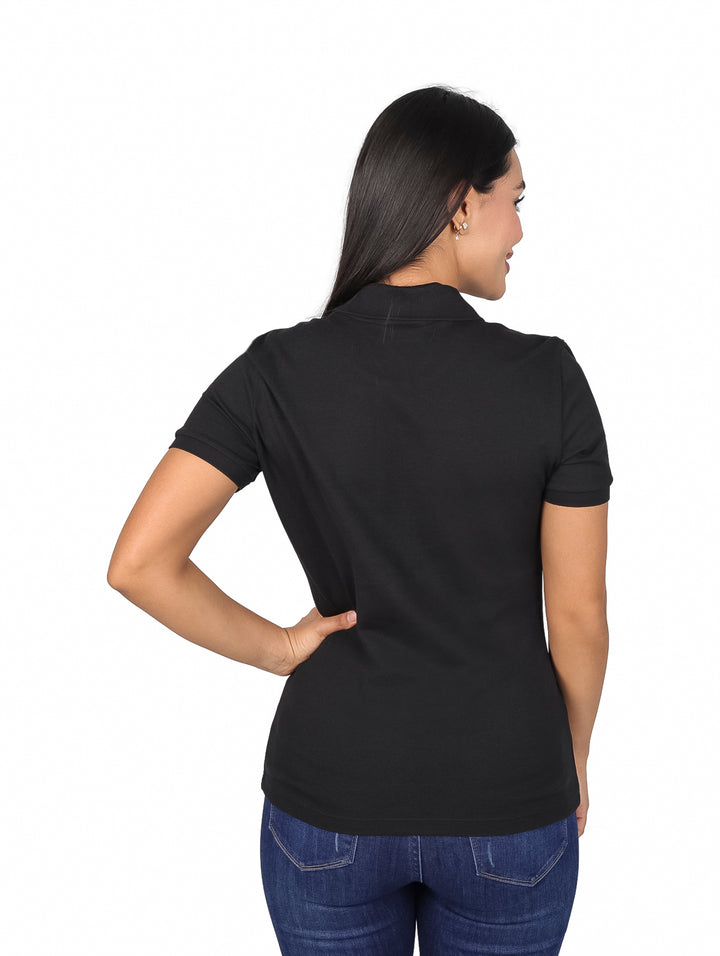 Mujer vistiendo una playera polo Lacoste de color negro y jeans azules.