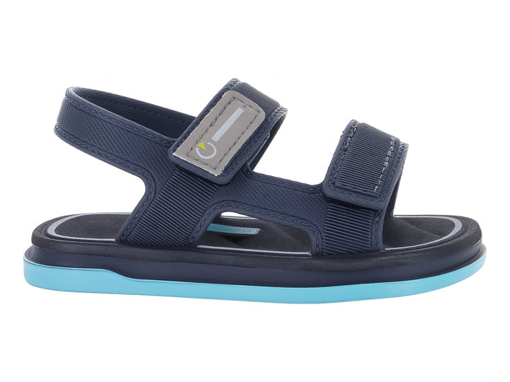 Sandalia infantil Cartago color gris oscuro con suela azul claro y correas ajustables.