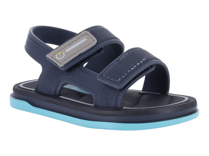 Sandalia infantil Cartago color gris oscuro con suela azul claro y correas ajustables.