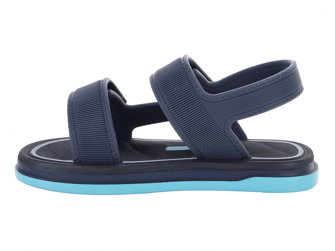Sandalia infantil Cartago color gris oscuro con suela azul claro y correas ajustables.