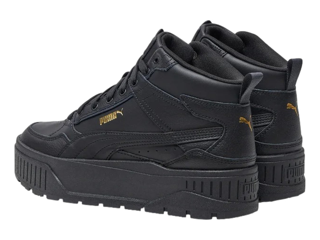 Tenis PUMA Carmen II Idol Mid en color negro con detalles dorados y suela de plataforma gruesa.