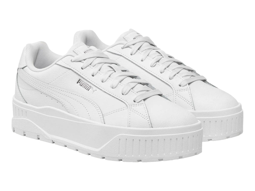 Tenis PUMA blancos con suela de plataforma gruesa y detalles plateados.