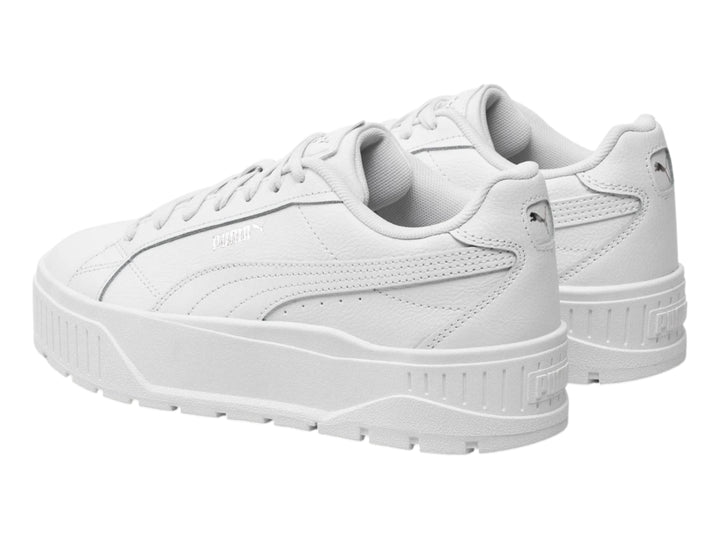Tenis PUMA blancos con suela de plataforma gruesa y detalles plateados.