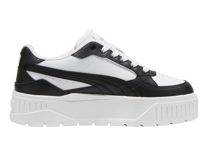 Tenis PUMA blancos y negros con suela de plataforma gruesa.