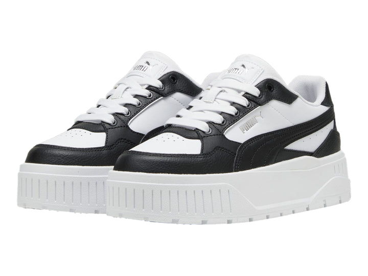 Tenis PUMA blancos y negros con suela de plataforma gruesa.