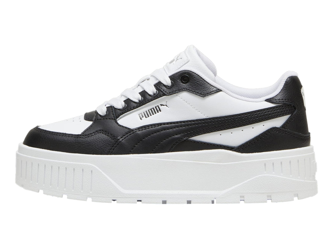 Tenis PUMA blancos y negros con suela de plataforma gruesa.