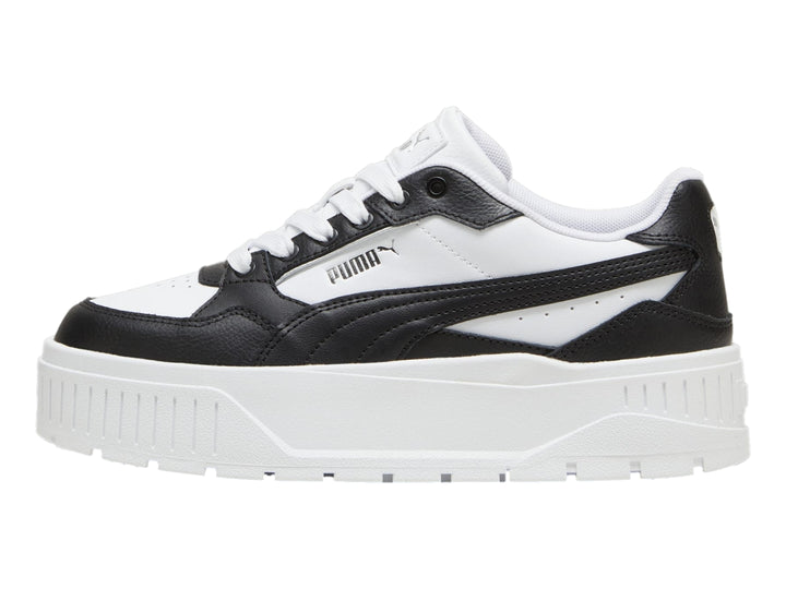Tenis PUMA blancos y negros con suela de plataforma gruesa.